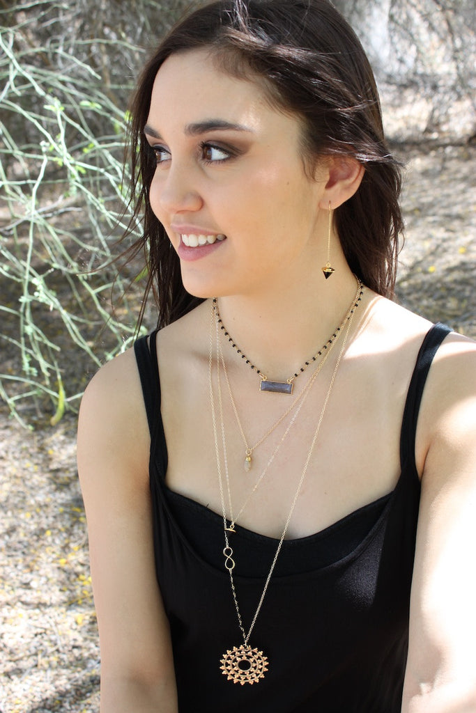layered gold necklaces in boho chic style by zoe and piper